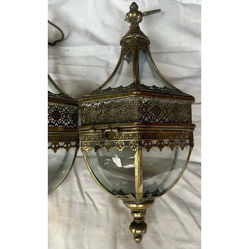 969 - Three decorative brass hanging lanterns with brackets for wall mounting. Lantern 53cm h approx.