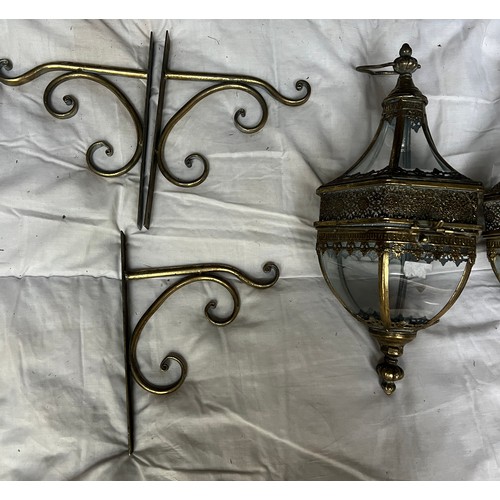 969 - Three decorative brass hanging lanterns with brackets for wall mounting. Lantern 53cm h approx.