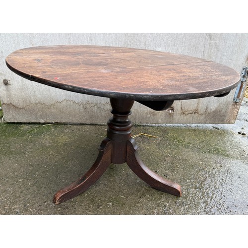 103 - A circular mahogany table. 76 d x 52cm h.