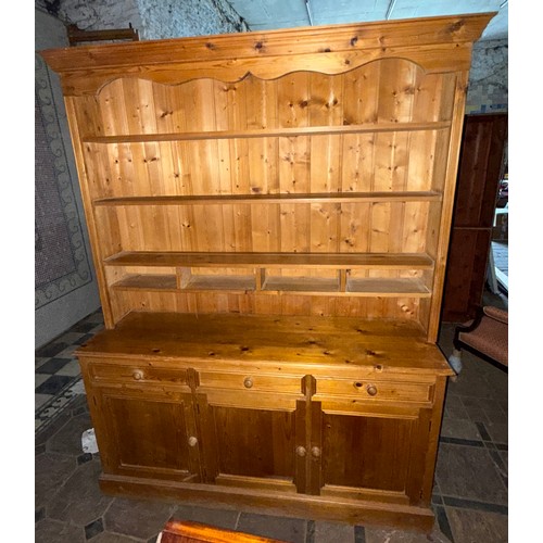 118 - A pine dresser, 3 cupboards and 3 drawers to base with shelved rack above.