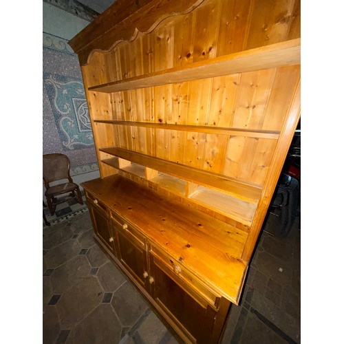 118 - A pine dresser, 3 cupboards and 3 drawers to base with shelved rack above.