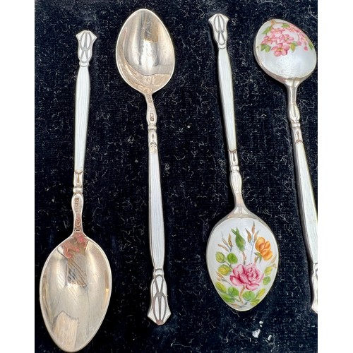 860 - Six boxed silver and enamel coffee spoons, each with differing floral decoration. Total weight 55gm.... 