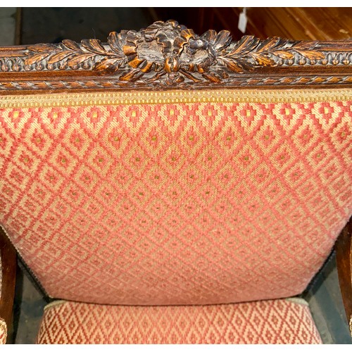 119 - A good quality well upholstered open armchair with carved wood surround.