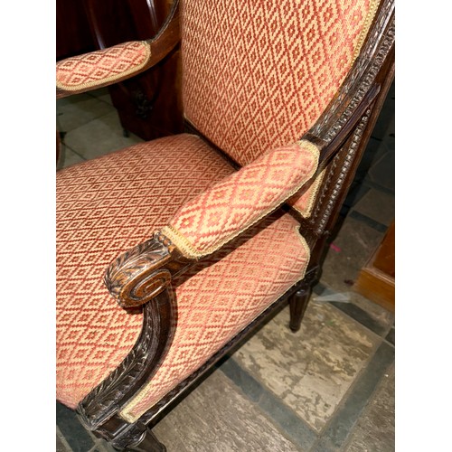 119 - A good quality well upholstered open armchair with carved wood surround.