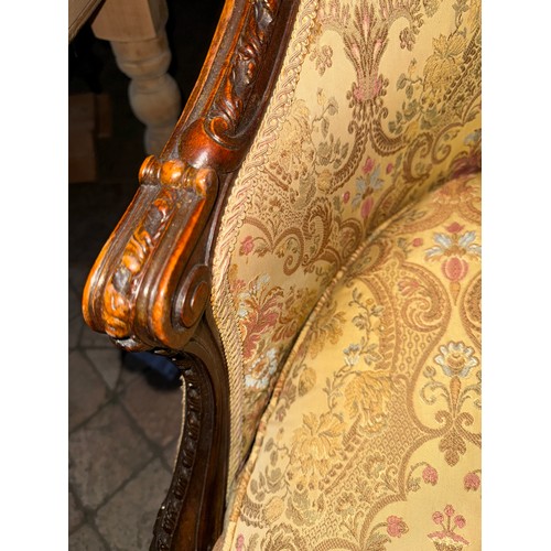 121 - A 19thC upholstered armchair with wood surround and loose cushion.