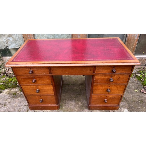 126 - A 19thC oak pedestal desk with tooled red leather top. 123cm w x 75cm h x 62cm d.