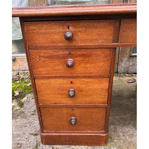 126 - A 19thC oak pedestal desk with tooled red leather top. 123cm w x 75cm h x 62cm d.