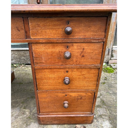 126 - A 19thC oak pedestal desk with tooled red leather top. 123cm w x 75cm h x 62cm d.