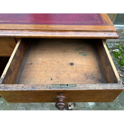 126 - A 19thC oak pedestal desk with tooled red leather top. 123cm w x 75cm h x 62cm d.