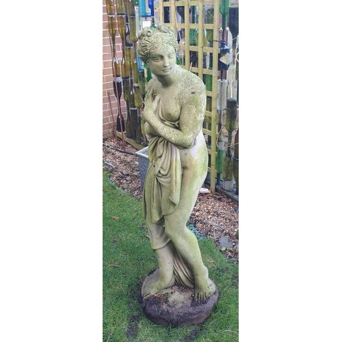 8 - A reconstituted stone statue of a scantily clad coy maiden. 126 h x 34cm at base.