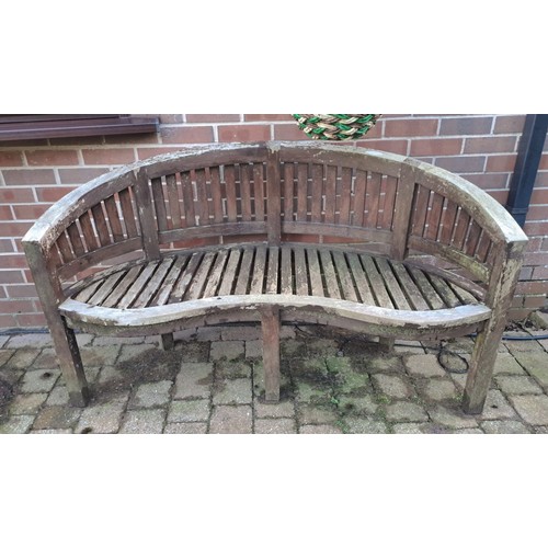 12 - A teak garden bench with serpentine front. 57 h x 152 w x 56cm d. 44cm h to seat.