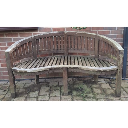 12 - A teak garden bench with serpentine front. 57 h x 152 w x 56cm d. 44cm h to seat.