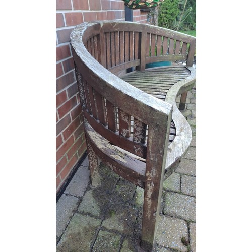 12 - A teak garden bench with serpentine front. 57 h x 152 w x 56cm d. 44cm h to seat.