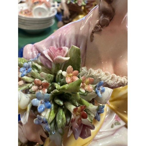 433 - A Sitzendorf lady with a flowered hat together with two Capodimonte figurines of lady with flowers a... 