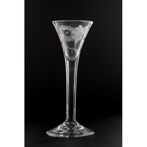 An engraved Jacobite wine glass, circa 1750. Drawn trumpet type engraved with rose spray, two buds, oak leaf and garter star, inscribed ‘Fiat’ on plain stem with conical foot. 15.3cm h. Formerly in the collection of Geoffrey Seddon. Ex Bonhams Scottish sale.