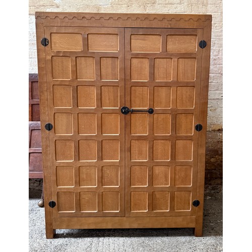 Robert ‘Mouseman’ Thompson oak panelled two door wardrobe with arcaded frieze and recessed mouse. The interior fitted with hanging rail and shelves. 167cm h x 122cm w x 57.5cm d.