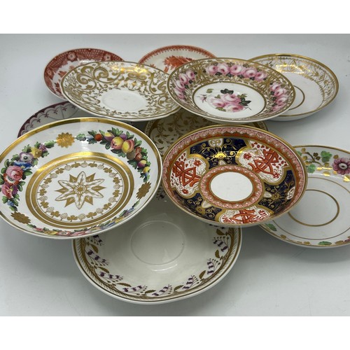 A group of early 19thC hand-painted porcelain saucers, mainly Spode ...