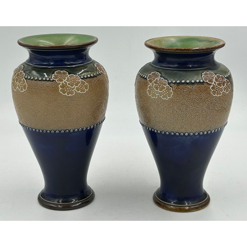 528 - A pair of Royal Doulton Lambeth stone ware vases with blue and green floral pattern one marked FJ to... 