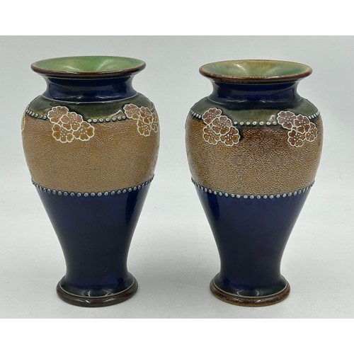 528 - A pair of Royal Doulton Lambeth stone ware vases with blue and green floral pattern one marked FJ to... 