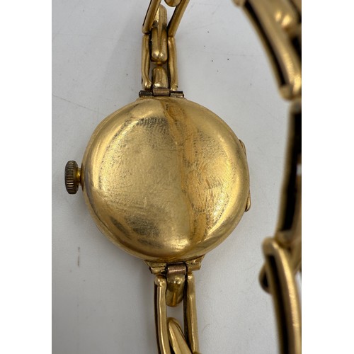 995 - An 18ct gold ladies wristwatch on expanding gold strap marked 18ct. Total weight 25.65gm.