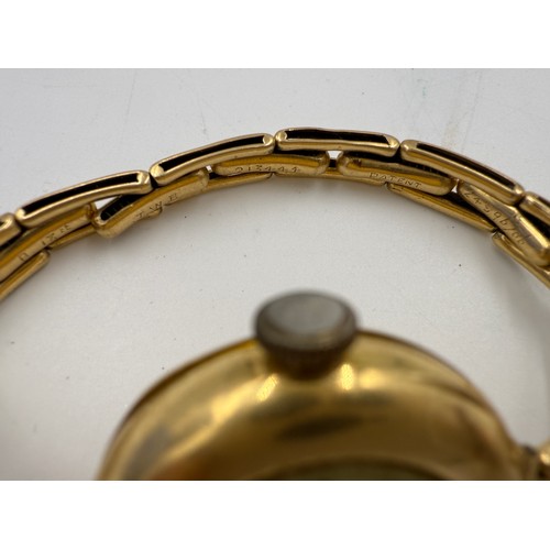 995 - An 18ct gold ladies wristwatch on expanding gold strap marked 18ct. Total weight 25.65gm.