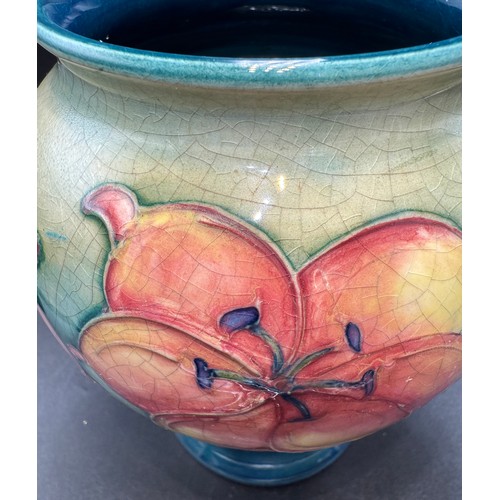 15 - A Moorcroft African Lily pattern vase. 15.5cm h. Signed in blue to base.