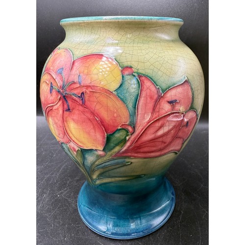 15 - A Moorcroft African Lily pattern vase. 15.5cm h. Signed in blue to base.