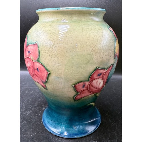 15 - A Moorcroft African Lily pattern vase. 15.5cm h. Signed in blue to base.