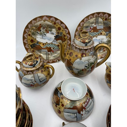 16 - An oriental tea service comprising 12 plates, 12 saucers, 9 cups, teapot, milk jug and sugar bowl.