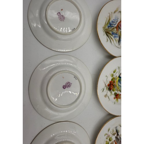 18 - A set of twelve 12cm diameter plates decorated with birds. All with crazing and some gilt rub to edg... 