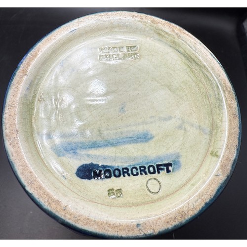 19 - An early 20thC Moorcroft Moonlit Blue pattern pottery vase with hammered pewter neck. 18cm h.