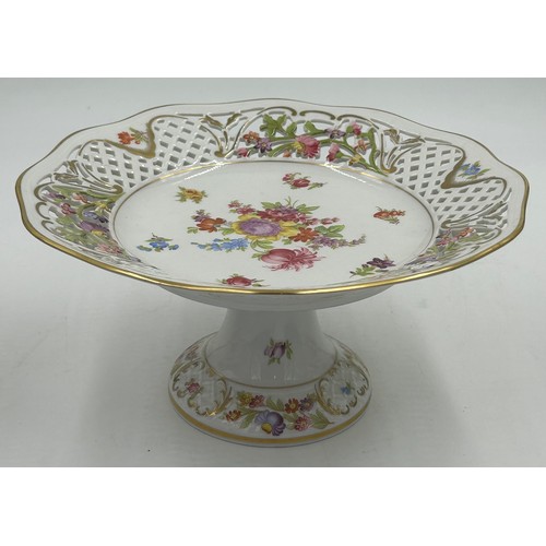 49 - Ceramics to include a pair of Continental pedestal comports with crossed sword mark to base, a pierc... 