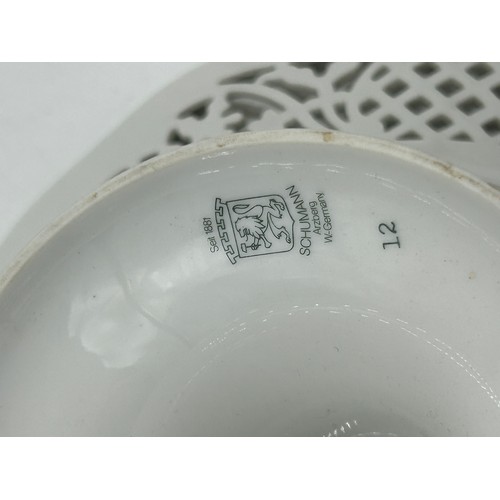 49 - Ceramics to include a pair of Continental pedestal comports with crossed sword mark to base, a pierc... 