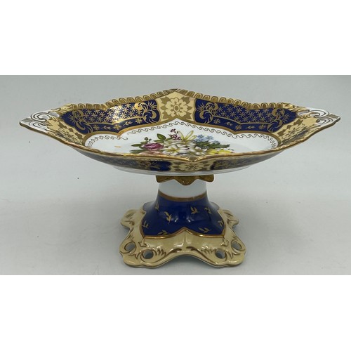 49 - Ceramics to include a pair of Continental pedestal comports with crossed sword mark to base, a pierc... 