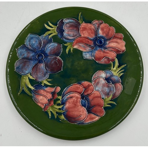 50 - Two Moorcroft Anemone patterned plates one in the green colourway 31cm d and one in blue 25.5cm d. B... 