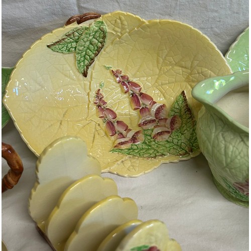 59 - A collection of Foxglove Carlton Ware in yellow and green comprising of dishes, plates, jugs, condim... 