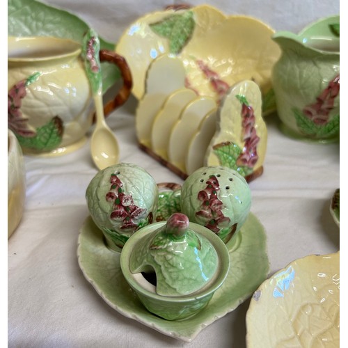 59 - A collection of Foxglove Carlton Ware in yellow and green comprising of dishes, plates, jugs, condim... 