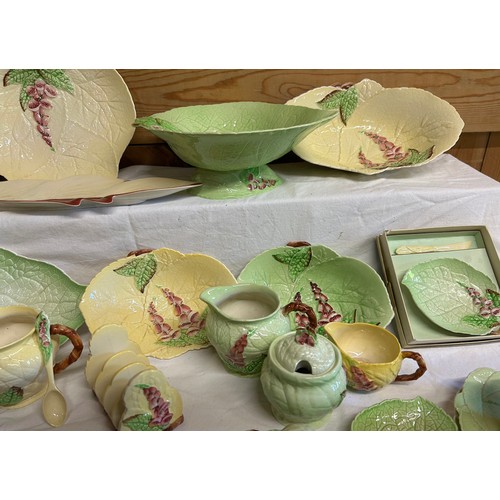 59 - A collection of Foxglove Carlton Ware in yellow and green comprising of dishes, plates, jugs, condim... 