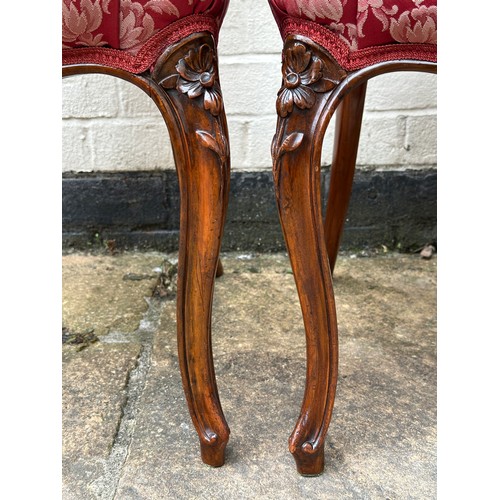 6 - A pair of Victorian mahogany framed salon chairs with floral carving. 86 h x 44 w x 44cm d. Height t... 