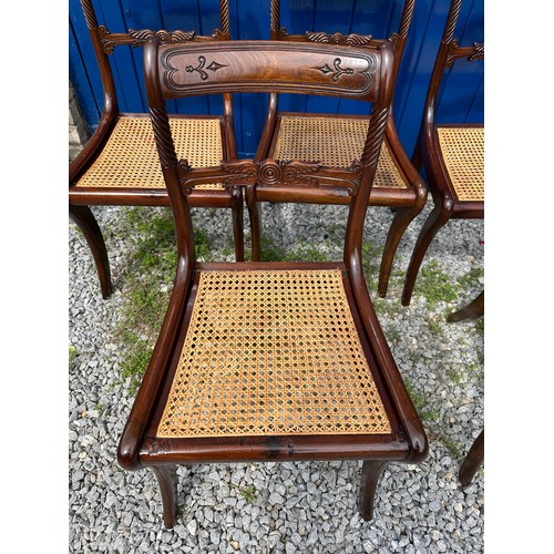 7 - A set of six Regency mahogany, bar backed dining chairs with cane seats and sabre legs to the front.... 