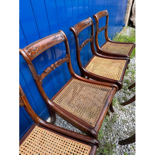 7 - A set of six Regency mahogany, bar backed dining chairs with cane seats and sabre legs to the front.... 