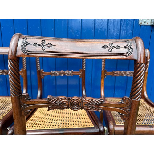 7 - A set of six Regency mahogany, bar backed dining chairs with cane seats and sabre legs to the front.... 