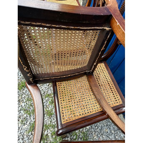 7 - A set of six Regency mahogany, bar backed dining chairs with cane seats and sabre legs to the front.... 