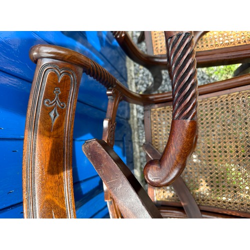 7 - A set of six Regency mahogany, bar backed dining chairs with cane seats and sabre legs to the front.... 