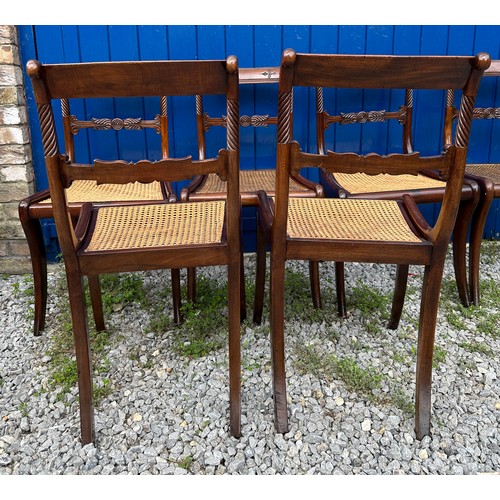 7 - A set of six Regency mahogany, bar backed dining chairs with cane seats and sabre legs to the front.... 
