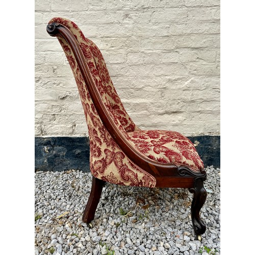 8 - A Victorian rosewood framed nursing chair with cabriole legs and brass castors. 94 h x 55 w x approx... 