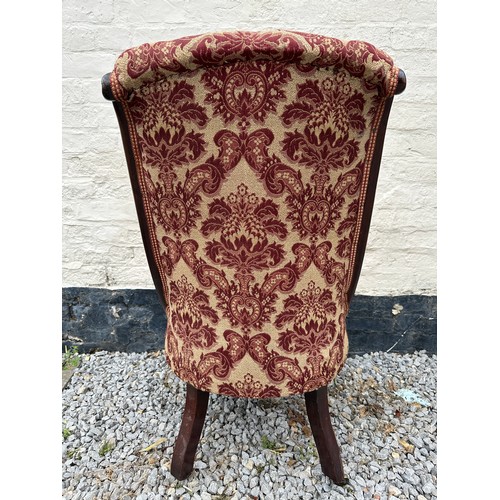 8 - A Victorian rosewood framed nursing chair with cabriole legs and brass castors. 94 h x 55 w x approx... 