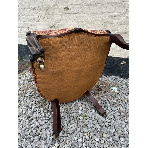 8 - A Victorian rosewood framed nursing chair with cabriole legs and brass castors. 94 h x 55 w x approx... 