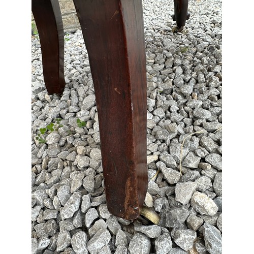 8 - A Victorian rosewood framed nursing chair with cabriole legs and brass castors. 94 h x 55 w x approx... 