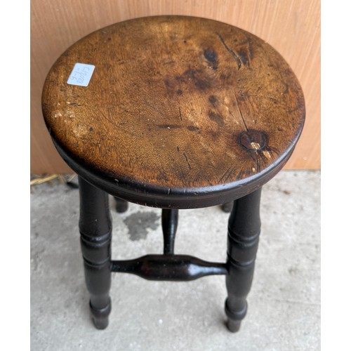 9 - A 19thC beech stool with circular top and turned legs. 54cm h.